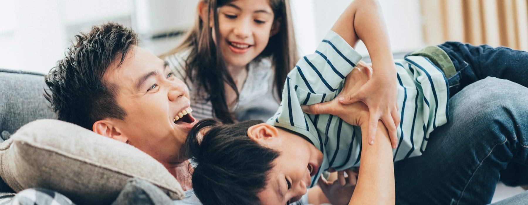 a family playing on a couch
